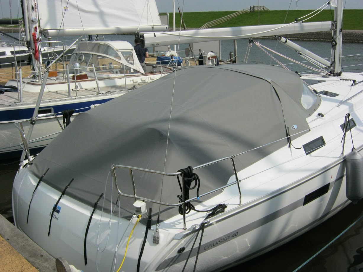 Gray harbor tent on white boat in harbor