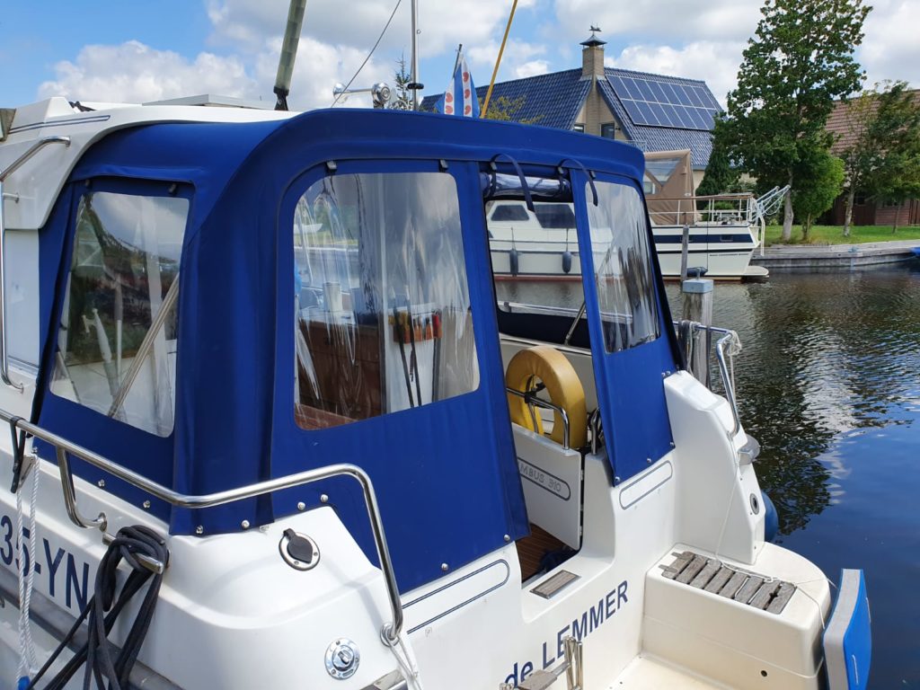Blue rear tent with windows on the water