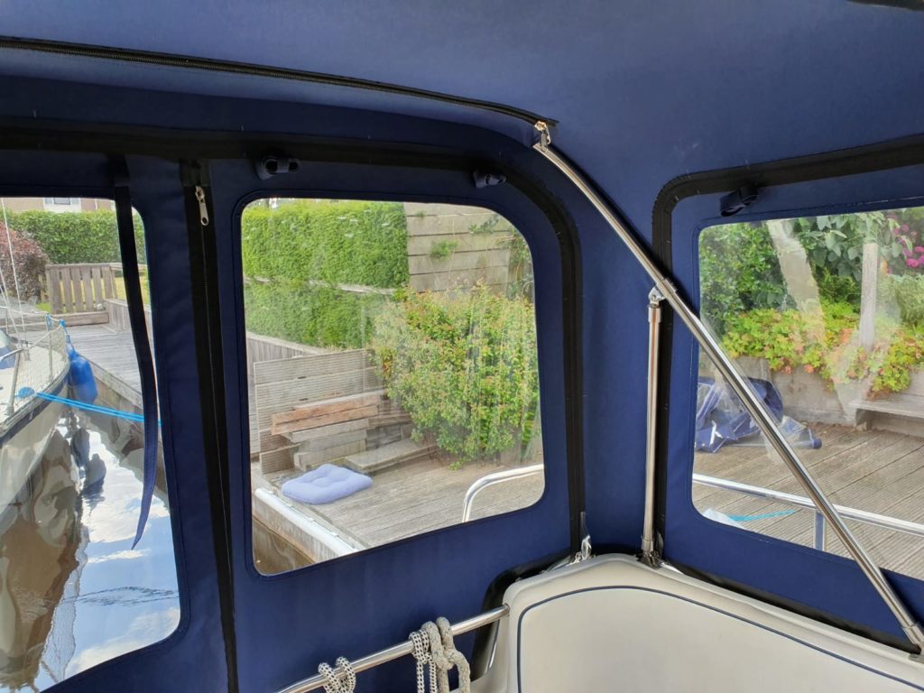 Blue rear tent with windows on the water