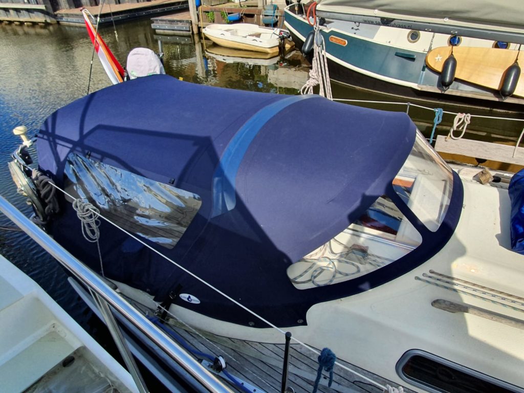Rear tent Blue on white boat in harbor