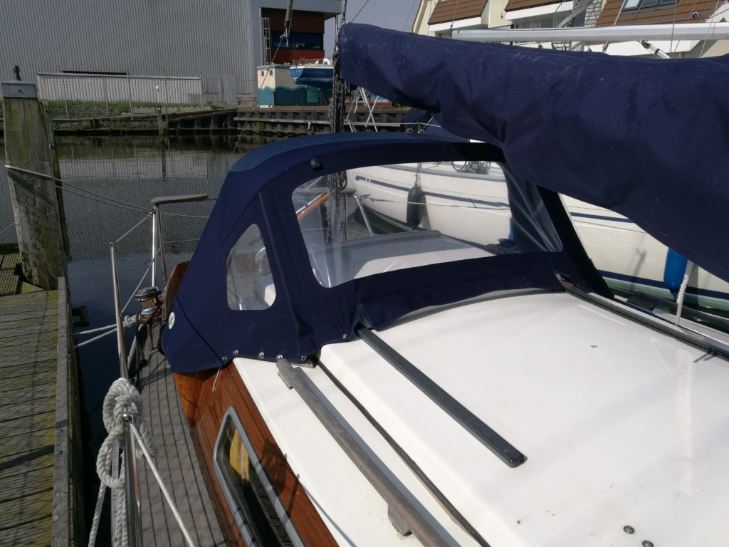 spray hood blue on white boat in harbor