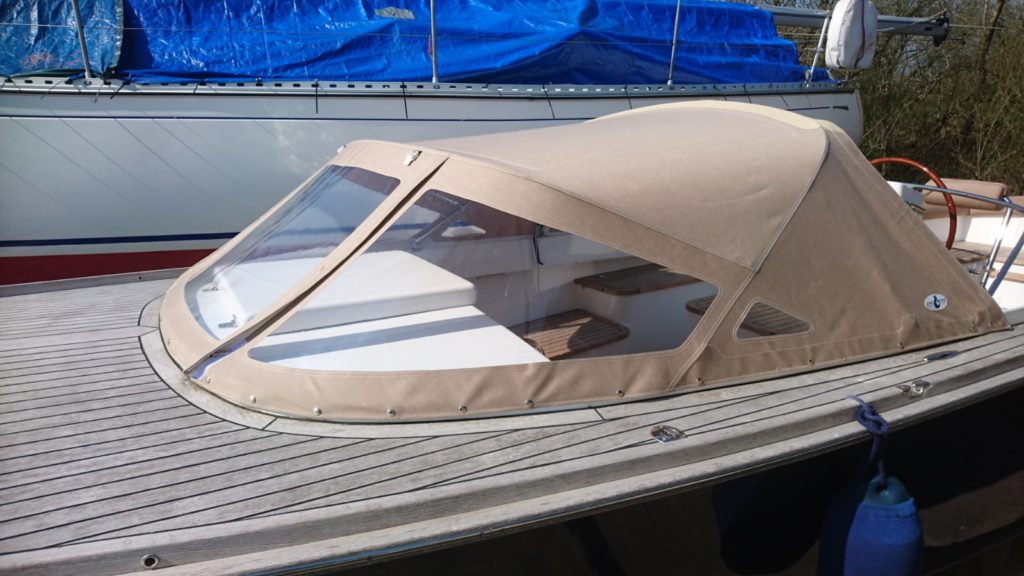 Tube hood Beige on wooden boat in harbor 
